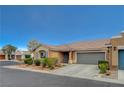 This one-story home boasts a well-kept lawn and a convenient attached two-car garage at 5245 Sand Dollar Ave, Las Vegas, NV 89141