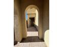 View of home's front door through an arched entryway with paved brick walkway at 5937 Armide St, North Las Vegas, NV 89081