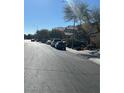 Street view of homes on a bright, sunny day with multiple cars parked on the side of the street at 5937 Armide St, North Las Vegas, NV 89081