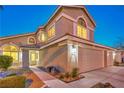 Charming two-story home with a well-manicured front yard and a three car garage at 6129 Flaming Arrow Rd, North Las Vegas, NV 89031