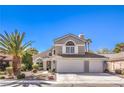 Charming two-story home with a well-manicured front yard, three car garage, and ample natural light at 6129 Flaming Arrow Rd, North Las Vegas, NV 89031