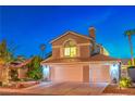 Charming two-story home with a well-manicured front yard and a three car garage at 6129 Flaming Arrow Rd, North Las Vegas, NV 89031
