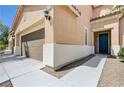 Inviting home exterior with a three-car garage, teal door, and well-kept landscaping at 6656 Fort William St, North Las Vegas, NV 89084