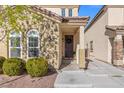 Charming entryway featuring a wreath on the front door and neat landscaping at 7078 Seabirds Pl, North Las Vegas, NV 89084