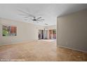 Spacious living room with tile flooring and a modern ceiling fan, perfect for relaxation at 730 Hardy Way # A, Mesquite, NV 89027
