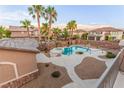 Backyard oasis with a sparkling pool, spa, and lush landscaping, perfect for outdoor entertaining at 7338 Flying Pegasus Ct, Las Vegas, NV 89131
