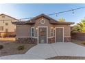 Cozy pool house with neutral stucco, rock details and two doors, perfect for entertaining at 7338 Flying Pegasus Ct, Las Vegas, NV 89131