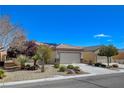 Charming single-story home featuring a well-manicured yard, desert landscaping, and a convenient two-car garage at 7564 Wingspread St, North Las Vegas, NV 89084