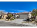 Charming single-story home featuring a well-manicured yard, desert landscaping, and a convenient two-car garage at 7564 Wingspread St, North Las Vegas, NV 89084