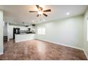 Open living room with tile floors, fan and bright recessed lighting, adjacent to the modern kitchen at 7649 Calico Fields St, Las Vegas, NV 89149