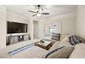 Comfortable living room featuring a ceiling fan, plush sectional, and access to the backyard at 7904 Fantail Dr, North Las Vegas, NV 89084