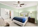 Inviting bedroom with a ceiling fan, ensuite bathroom, and a neutral color palette at 7904 Fantail Dr, North Las Vegas, NV 89084