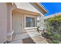 Inviting front porch with security gate and desert plants at 8472 W Gilmore Ave, Las Vegas, NV 89129