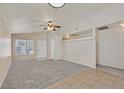 Bright living room features neutral paint, large window, and a ceiling fan at 8472 W Gilmore Ave, Las Vegas, NV 89129