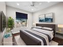 Bedroom offers a large window, sleek TV, soft rug and stylish decor at 8705 Red Brook Dr # 203, Las Vegas, NV 89128