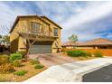 Stylish two-story home with a brick driveway, a two car garage, and manicured landscaping in a suburban neighborhood at 9160 Lynea Ct, Las Vegas, NV 89178