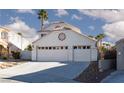 Home features a three-car garage, and a lovely desert landscaped yard at 9520 Wooden Pier Way, Las Vegas, NV 89117