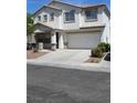 Charming two-story home with a two car garage, a well-manicured front yard and long driveway at 9792 Cordova Vista Ct, Las Vegas, NV 89183