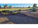 Backyard area showing a brick retaining wall and view of the golf course at 9937 Villa Ridge Dr, Las Vegas, NV 89134