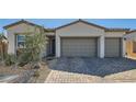 Charming one-story home boasting a three-car garage, stone accents, and a neatly landscaped front yard at 10239 Meandering Dell Ave, Las Vegas, NV 89166