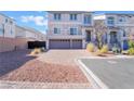 Inviting two-story home featuring a two-car garage, landscaped front yard, and paved driveway at 10319 Santero Bay Ct, Las Vegas, NV 89141