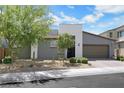 Beautiful gray stucco single-story home with a desert landscape in the front yard at 1609 Dream Canyon Ave, North Las Vegas, NV 89084