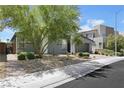 Charming gray stucco single-story home with desert landscaping and a brick pathway to the front at 1609 Dream Canyon Ave, North Las Vegas, NV 89084