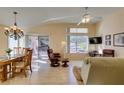 Bright living room featuring hardwood floors, a ceiling fan, and sliding glass doors to the patio at 2037 Poppywood Ave, Henderson, NV 89012