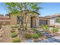 Attractive single-story home with stone accents, low maintenance landscaping, and a brick paved walkway at 243 Sun Glaze Ave, Henderson, NV 89011