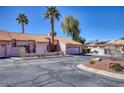 Alluring home featuring desert landscaping, a tile roof, and a convenient two-car garage at 2699 Aldonza Dr, Henderson, NV 89014