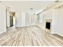 Bright living room with light wood floors and white walls and a fireplace at 2773 Drumlanrig St, Henderson, NV 89044