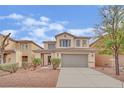 Charming two-story home with a well-manicured lawn and a two-car garage at 3221 Birdwatcher Ave, North Las Vegas, NV 89084