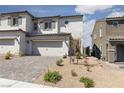Charming two-story home showcasing a two-car garage and low-maintenance desert landscaping at 378 Rosefinch St, Henderson, NV 89012