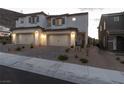 Inviting two-story home featuring a two-car garage, neutral paint, and desert landscaping at 378 Rosefinch St, Henderson, NV 89012