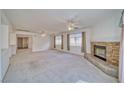 Spacious living room with plush carpeting, a cozy fireplace, and lots of natural light at 3891 Sedgwick, Pahrump, NV 89061