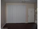 Bright living room featuring vinyl flooring, vertical blinds, and outdoor access at 5130 S Jones Blvd # 108, Las Vegas, NV 89118