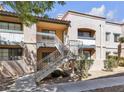 Building exterior showcasing stairs leading to the second level with maintained landscaping at 5162 S Jones Blvd # 106, Las Vegas, NV 89118