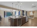 Modern open kitchen with a large island, stainless steel appliances, and hardwood floors at 6021 Vista Clara St, Las Vegas, NV 89148