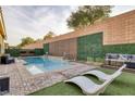 Private backyard pool with lounge chairs and landscaped surroundings, perfect for relaxation at 6021 Vista Clara St, Las Vegas, NV 89148