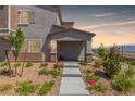 Inviting home entrance with a landscaped walkway and picturesque desert surroundings at 6208 Rathbone St, Las Vegas, NV 89166