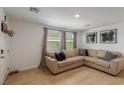 Cozy living room with modern decor, including a comfortable sectional sofa and contemporary artwork at 6208 Rathbone St, Las Vegas, NV 89166