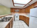 Well-lit kitchen with ample counter space, white appliances, and wood cabinetry at 6250 W Flamingo Rd # 135, Las Vegas, NV 89103