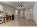Inviting living room with neutral colors, tile flooring, and a ceiling fan for added comfort at 6457 Lovett Canyon St, Las Vegas, NV 89148