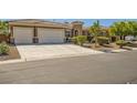 Beautiful, single-story home featuring a neutral color palette, tile roof, and two car garage with a well manicured front yard at 6527 Lokai Ave, Las Vegas, NV 89130