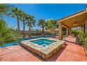 Stunning backyard features a dazzling pool and spa, and covered patio with ample seating for outdoor entertainment at 6527 Lokai Ave, Las Vegas, NV 89130