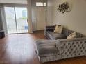 The stylish living room with hardwood floors, sliding doors to the balcony, and neutral decor at 700 Carnegie St # 2013, Henderson, NV 89052