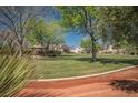 Beautiful community green space with mature trees, landscaping, and walking paths at 7624 Molfetta St, Las Vegas, NV 89149