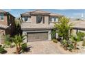 Two-story home with a tile roof, brick driveway, desert landscaping, and an attached two-car garage at 7837 Hamilton Pool Dr, Las Vegas, NV 89113