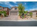 Charming two-story home with desert landscaping, brick driveway, and an attached two-car garage at 7837 Hamilton Pool Dr, Las Vegas, NV 89113