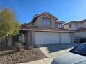Lovely two-story home with a three-car garage, desert landscaping, and inviting curb appeal at 8401 Luna Bay Ln, Las Vegas, NV 89128